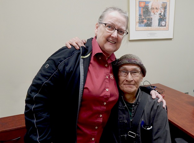 John (right) receives hug from Salvation Army worker, Val (left)