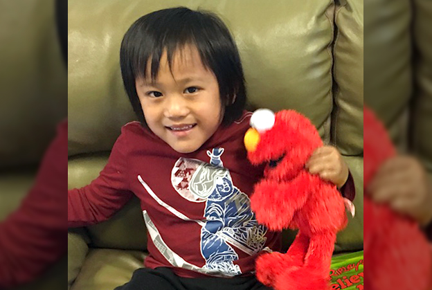 Elijah plays with stuffed toy at autism program