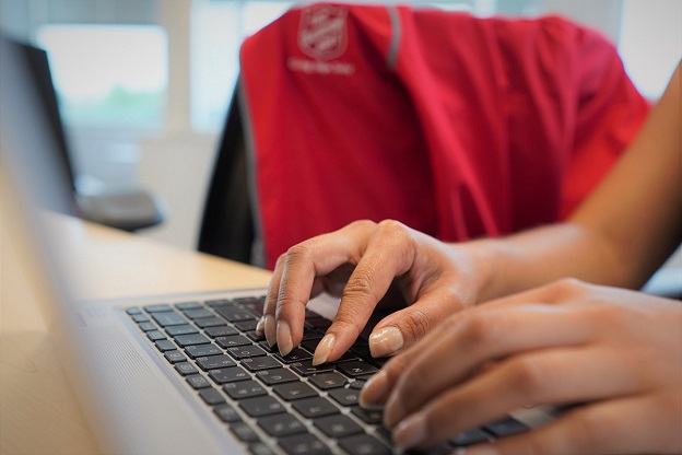 volunteer hands at a keyboard doing office work