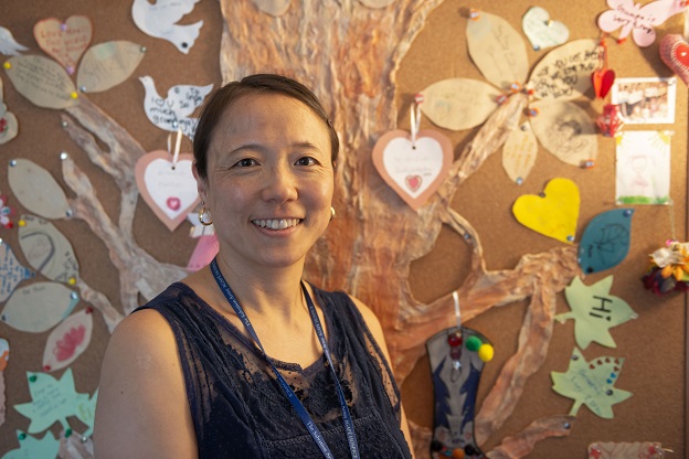 Social worker, Shizuko Boga, stands in front of crafts used to help grieving children express grief