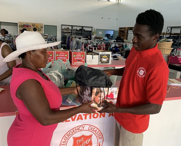 Salvation Army worker gives supplies to survivor of Hurricane Dorian