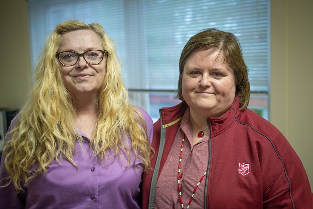 Denise (left) stands with Salvation Army worker (right)