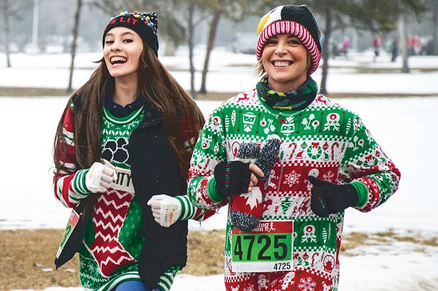 Two santa shuffle participants dressed in festive gear