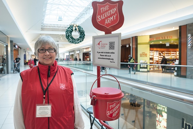 Volunteer stands at kettle to support annual fundraising campaign