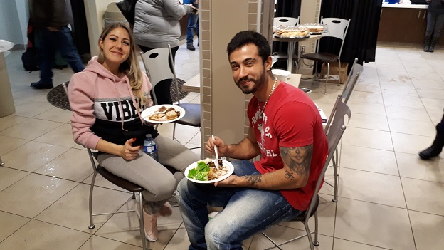 Two stranded passengers eat meal provided by The Salvation Army
