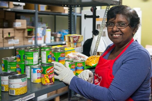 Salvation Army volunteer stocks food shelves