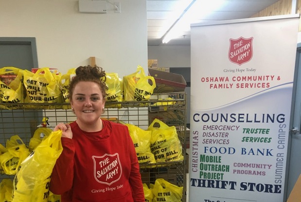 Paige packs food bags at Salvation Army Oshawa community and family services