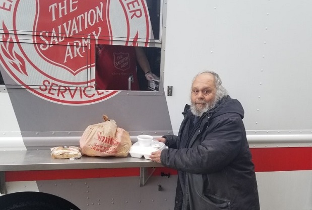 Guest receives lunch at Salvation Army mobile feeding unit