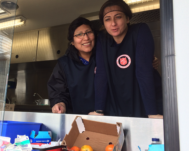Salvation Army workers hand out food to people affected by COVID-19