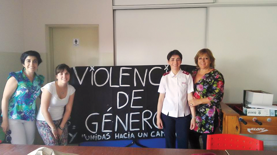 violence against women poster and women standing beside it