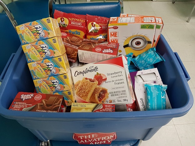 bin of snacks including five alive, granola bars, raisins