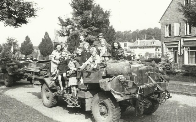 Family members are pictured sitting on jeep