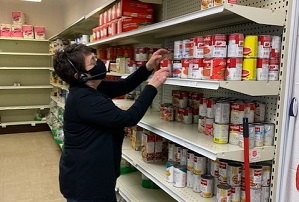Judy stocks shelves as requests for food increase