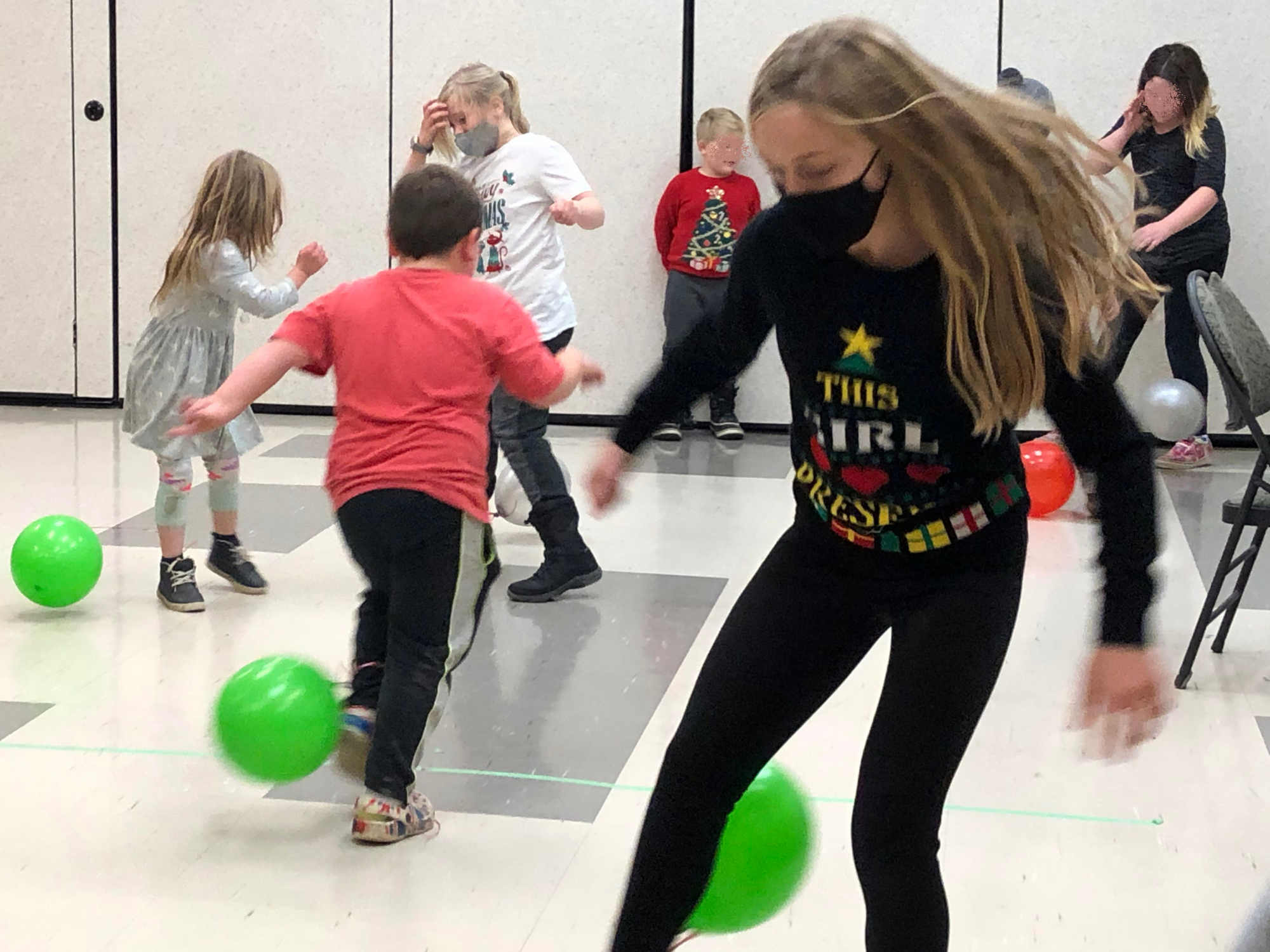 youth kick around green and red balls