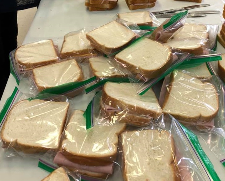 A table full of prepared sandwiches in ziploc bags