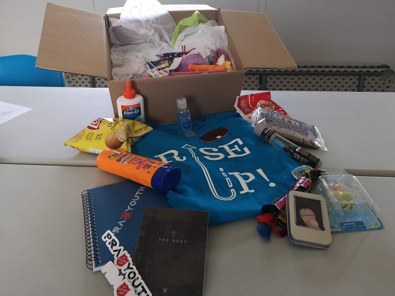 Camp in a box includes t-shirt, glue, sunscreen, snacks and crafts