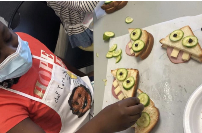 program participant creates unique and fun sandwich using pickles and cheese