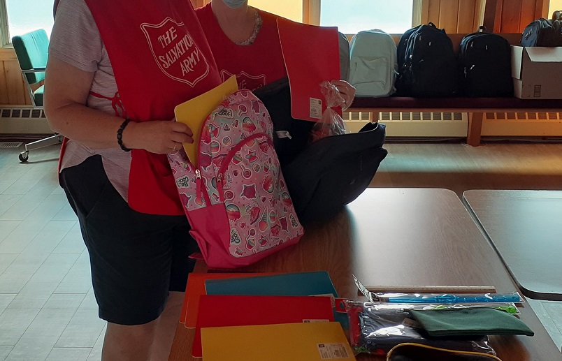 Salvation Army volunteer packs backpacks