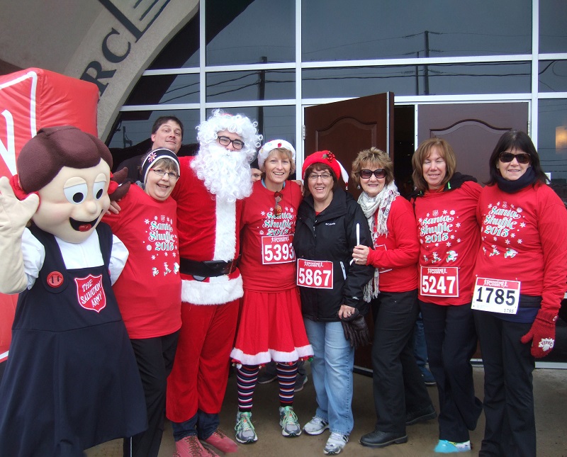 Santa shuffle participants stand with Santa and Salvation Army mascot
