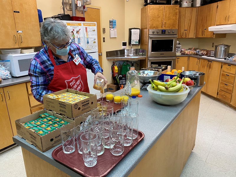 Salvation Army volunteer prepares food for winter cafe