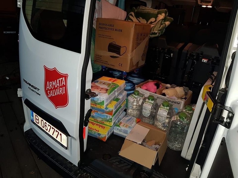 van with Salvation Army logo and food supplies