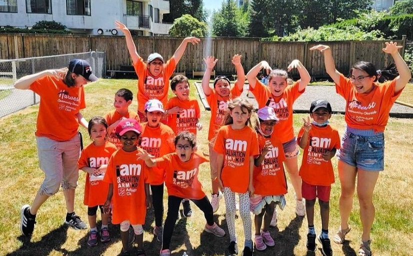 Children and youth outside cheering for summer camp