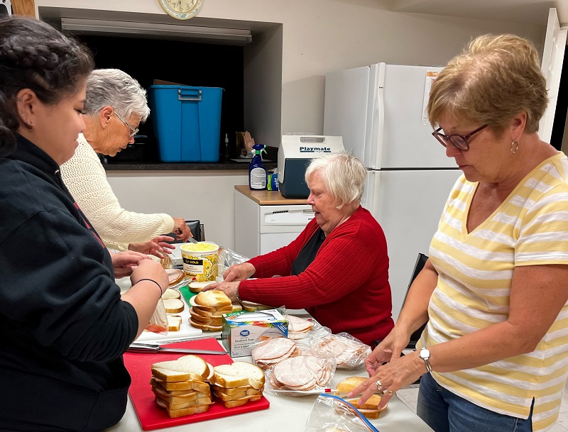 volunteers prepare sandwiches