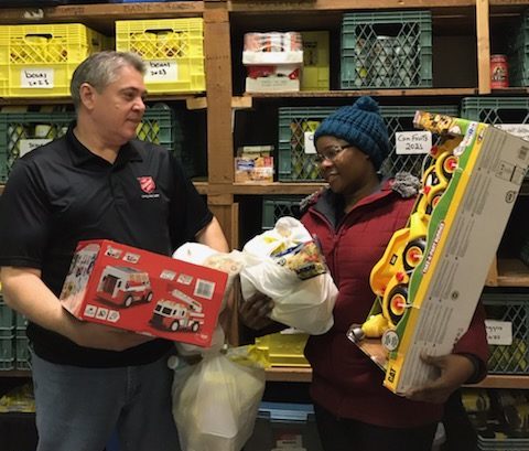 Salvation Army worker hands toys to client