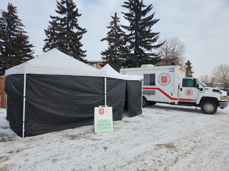 Mobile warming tent with Salvation Army emergency disaster vehicle alongside