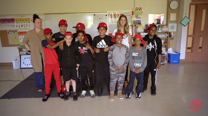 student graduates with their red caps