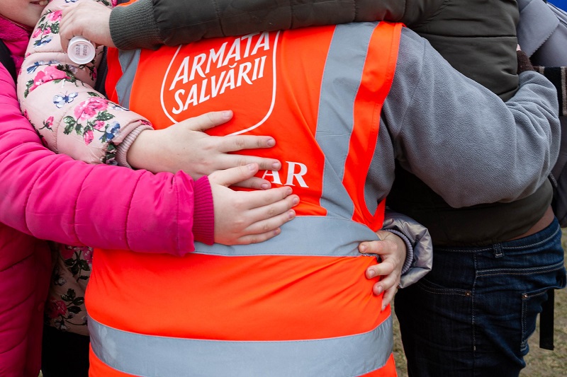 Salvation Army worker huddles and encourages those affected by war