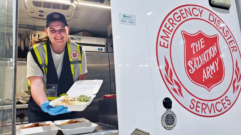 EDS worker serves meal out of community response unit