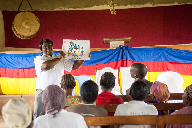 Salvation Army Kenya. Worker teaches at mother and child health program