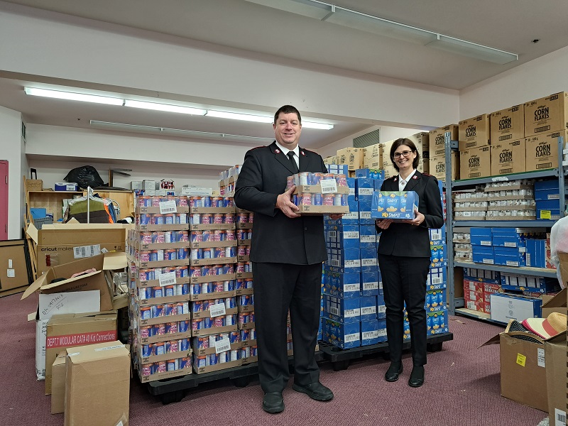 Lt's Jason and Janice Brinson hold food items for distribution from the food bank