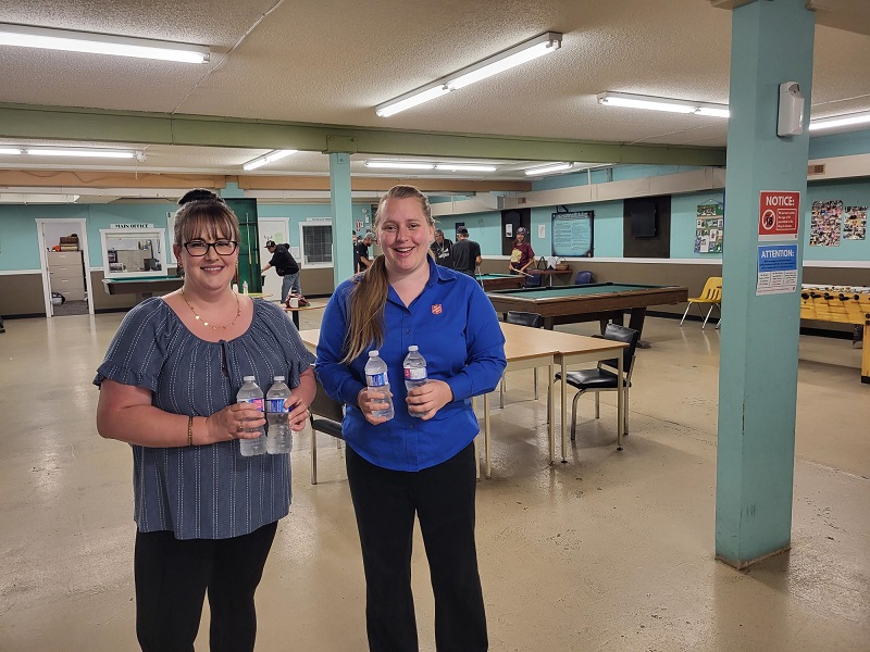 staff at drop-in centre hold bottles of water