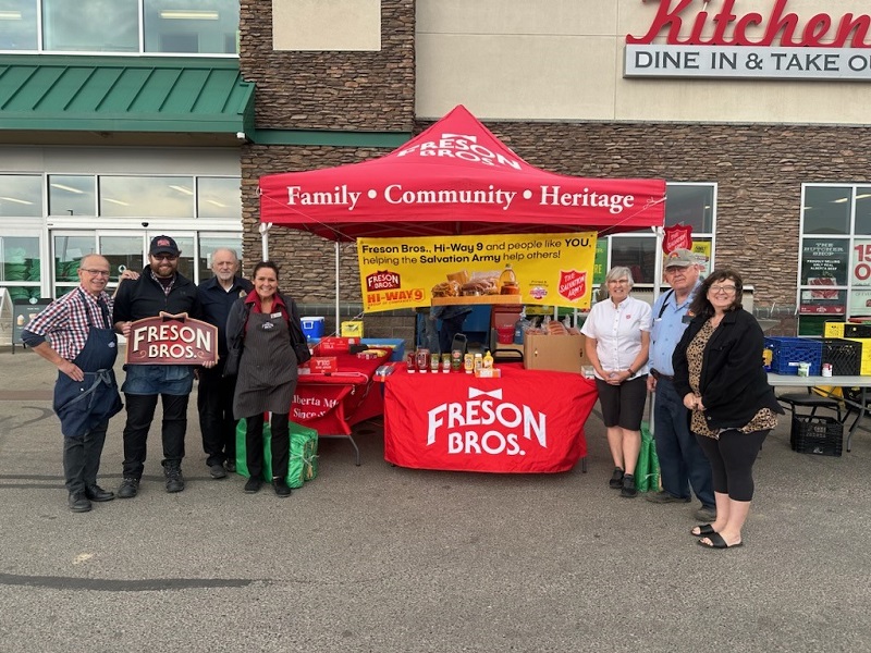 Community partners stand together with donated food items