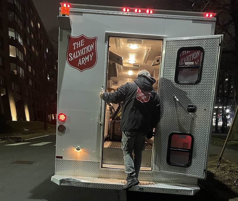 Client at the back door of EDS truck to receive food