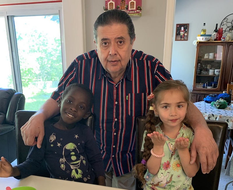 Enrique with two home day care children who benefit from Salvation Army parent-child program