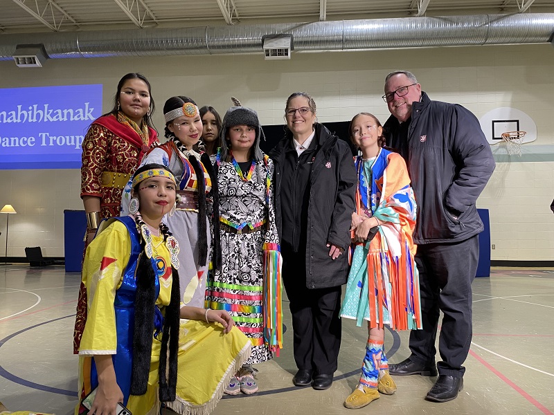 Salvation Army workers stand alongside staff and students of the St. Francis Cree Bilingual School