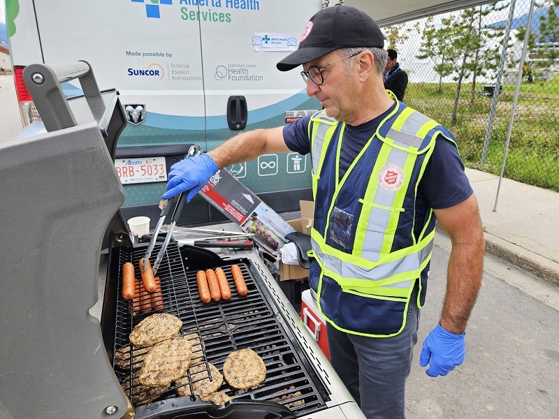 Robert takes charge of the grill, preparing lunch for staff, volunteers, and first responders on the scene.