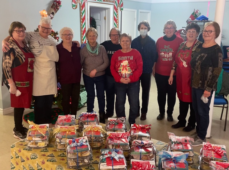 Salvation Army workers stand in front of bereavement packages ready for delivery