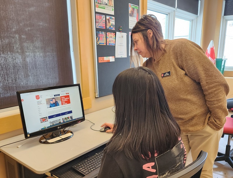two ladies infront of computer