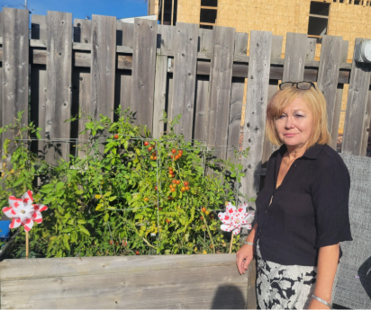 woman standing beside garden